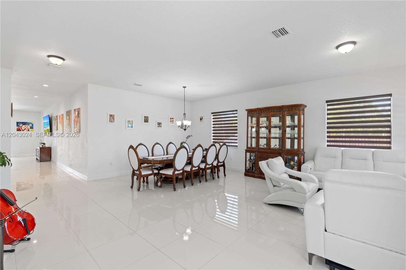 A bright, open-concept dining and living area features white tile floors and white walls — 21365 SW 177th Ct, Miami FL 33187, MIAMI, FL