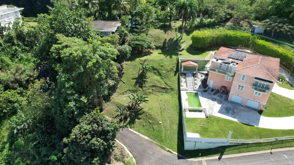 An aerial view shows a multi-story house with a pool, driveway, and surrounding green landscape — 3 CALLE CAGUAX, CAROLINA, PR