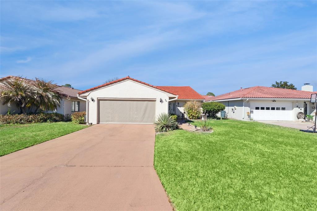 A single-story house with a red tile roof and a large front lawn — 688 AUGUSTA ROAD, WINTER HAVEN, FL