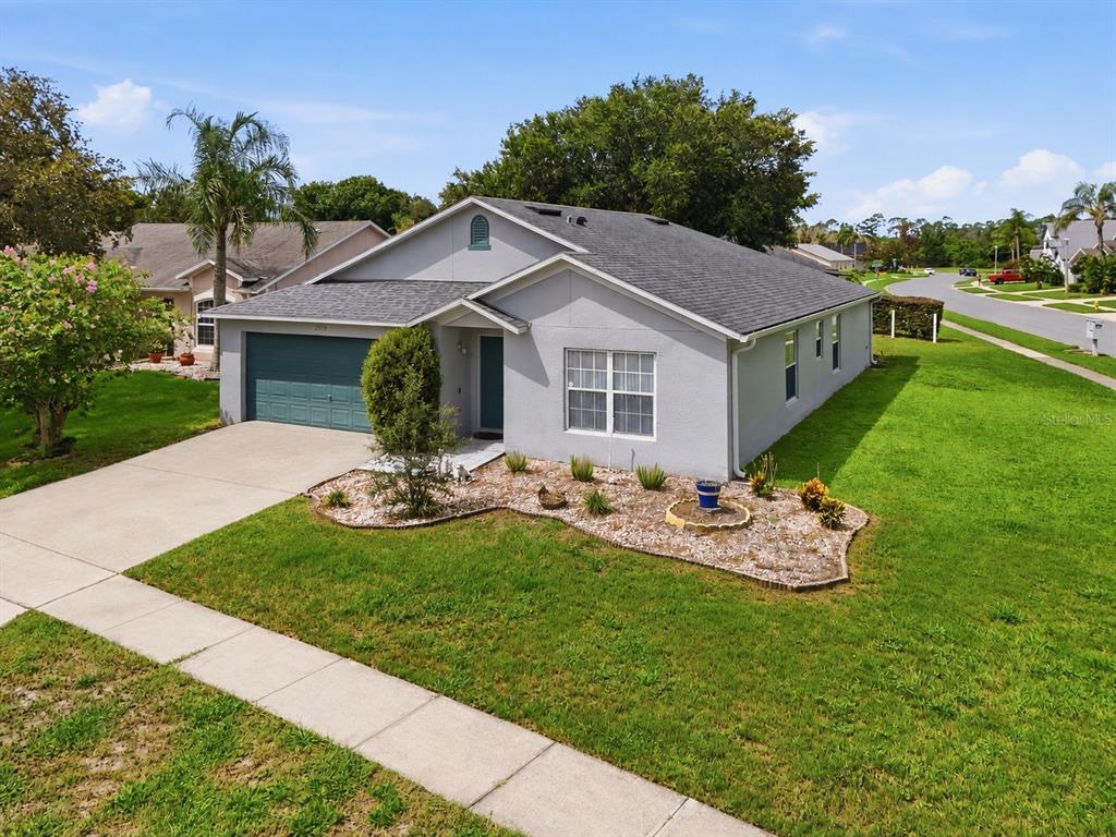 A single-story house with a gray exterior, a two-car garage, and a landscaped front yard — 2512 ABACUS COURT, LAKE MARY, FL