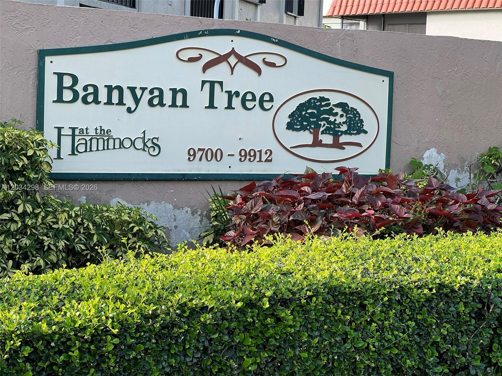 A sign for Banyan Tree at the Hammocks stands in front of a hedge and wall — 9710 Hammocks Blvd # 31, Miami FL 33196, MIAMI, FL
