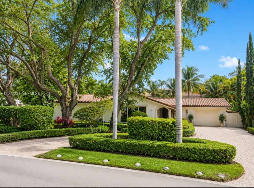 A single-story house with a tile roof, a paved driveway, and manicured hedges — 7980 SW 52nd Ave, Miami FL 33143, MIAMI, FL