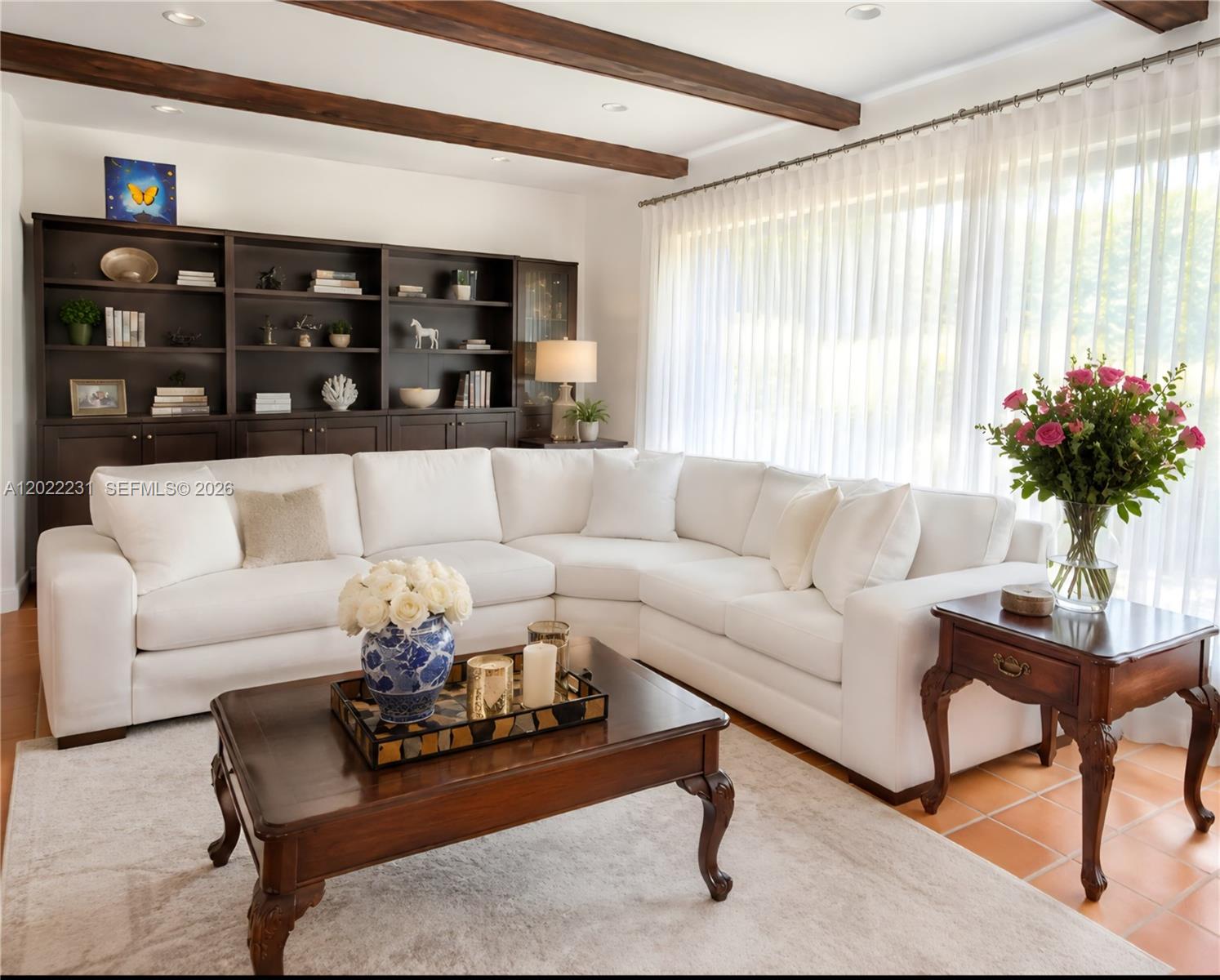 A living room features a white sectional sofa, dark wood coffee table, and built-in shelving — 7980 SW 52nd Ave, Miami FL 33143, MIAMI, FL