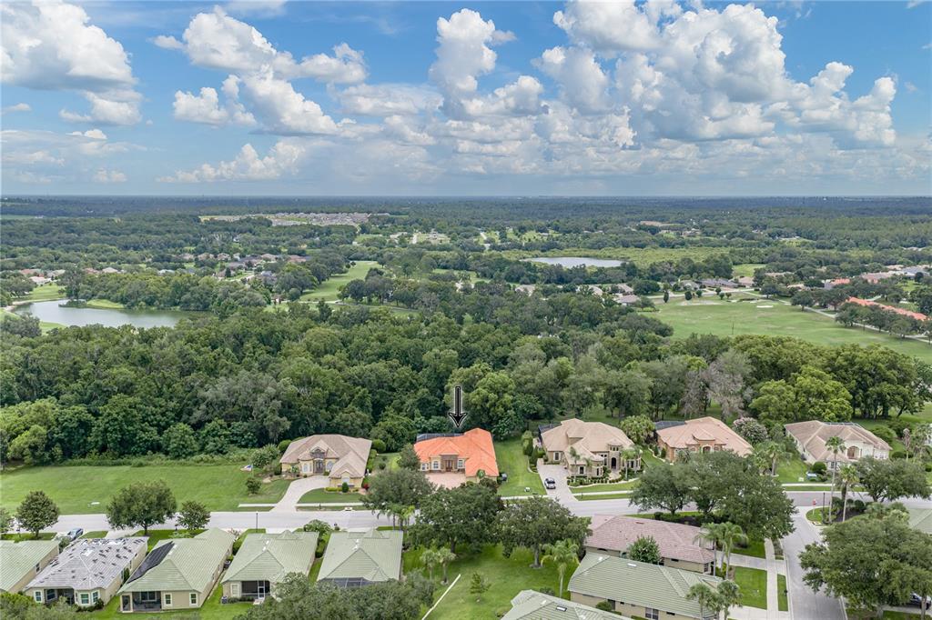 An aerial view shows a residential neighborhood with a house marked by a downward arrow — 13140 TRADITION DRIVE, DADE CITY, FL