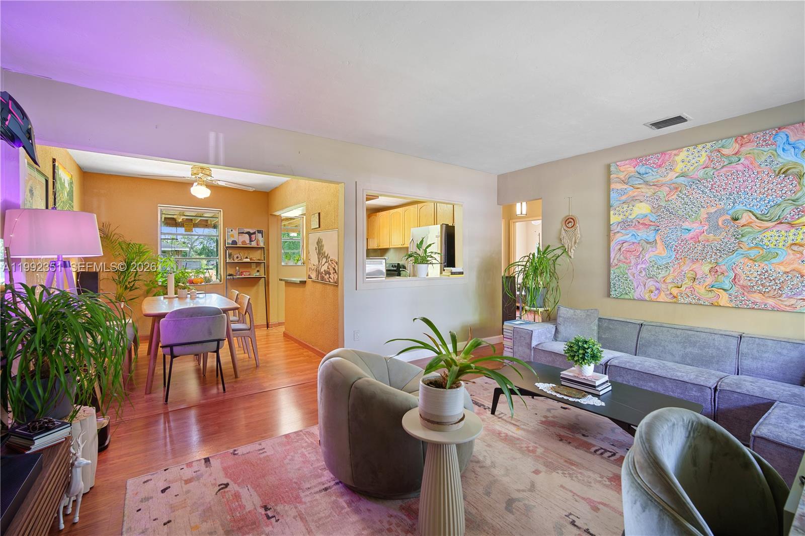A living room with a grey sofa, two armchairs, and an adjacent dining area — 14031 NW 5th Ave, Miami FL 33168, MIAMI, FL