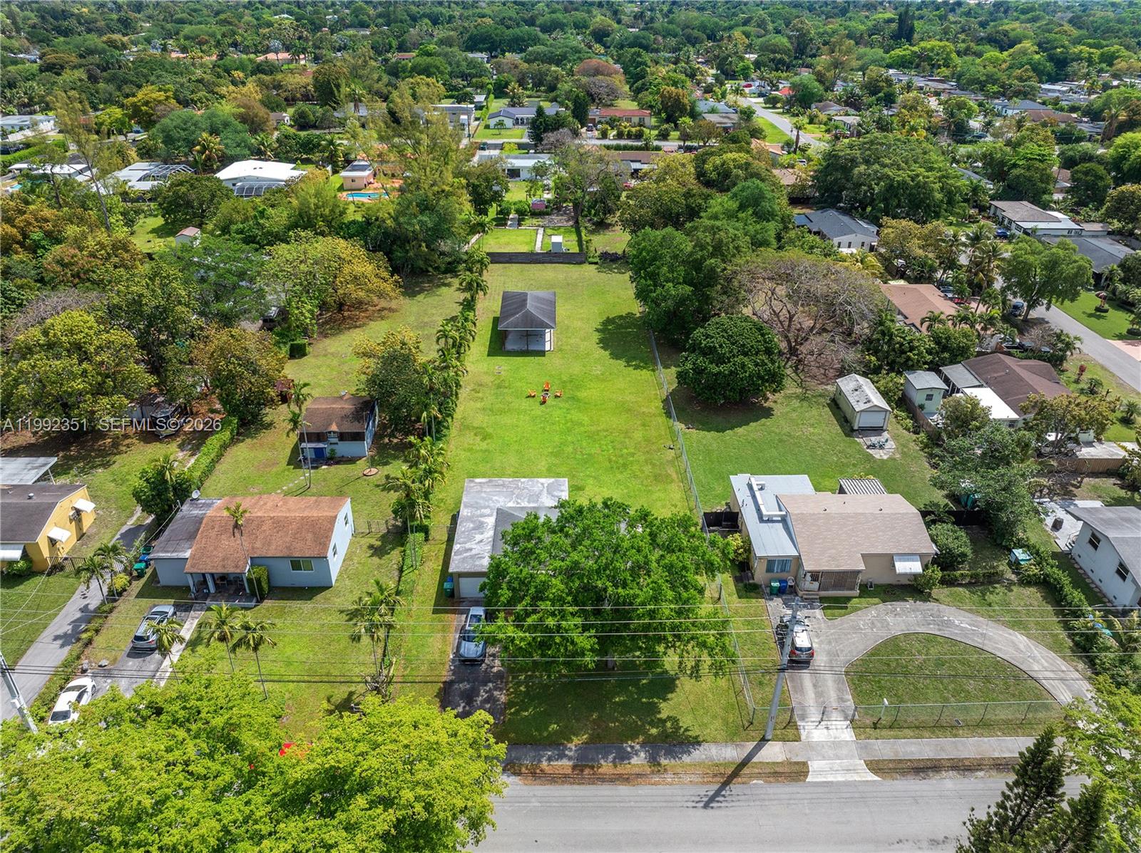 An aerial view shows three residential lots with houses, large grassy yards, and mature trees — 14031 NW 5th Ave, Miami FL 33168, MIAMI, FL