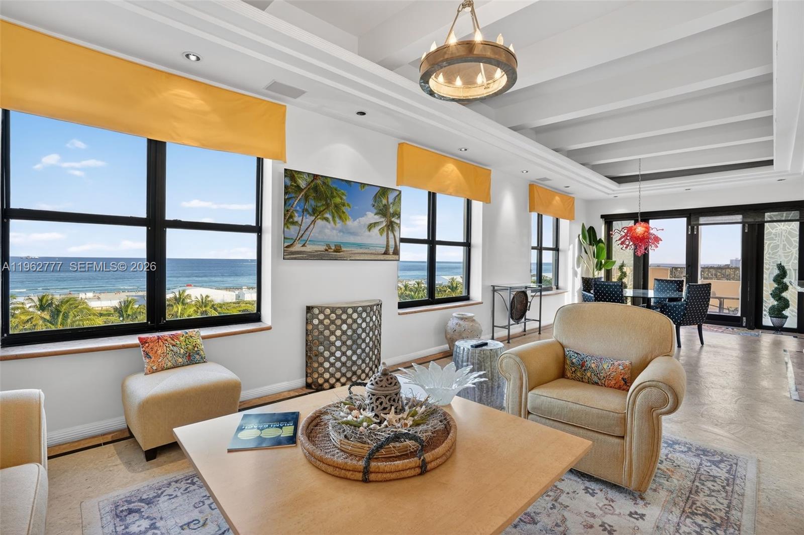 A spacious outdoor terrace features stone flooring, beige walls, and a metal railing overlooking the ocean — 1330 Ocean Dr, Miami Beach FL 33139, MIAMI BEACH, FL