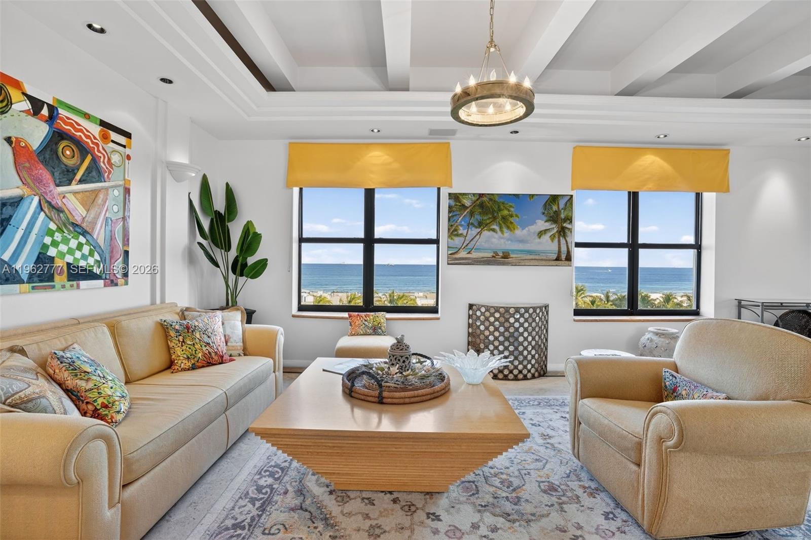 A living room features a beige sofa, armchair, wooden coffee table, and ocean views — 1330 Ocean Dr, Miami Beach FL 33139, MIAMI BEACH, FL