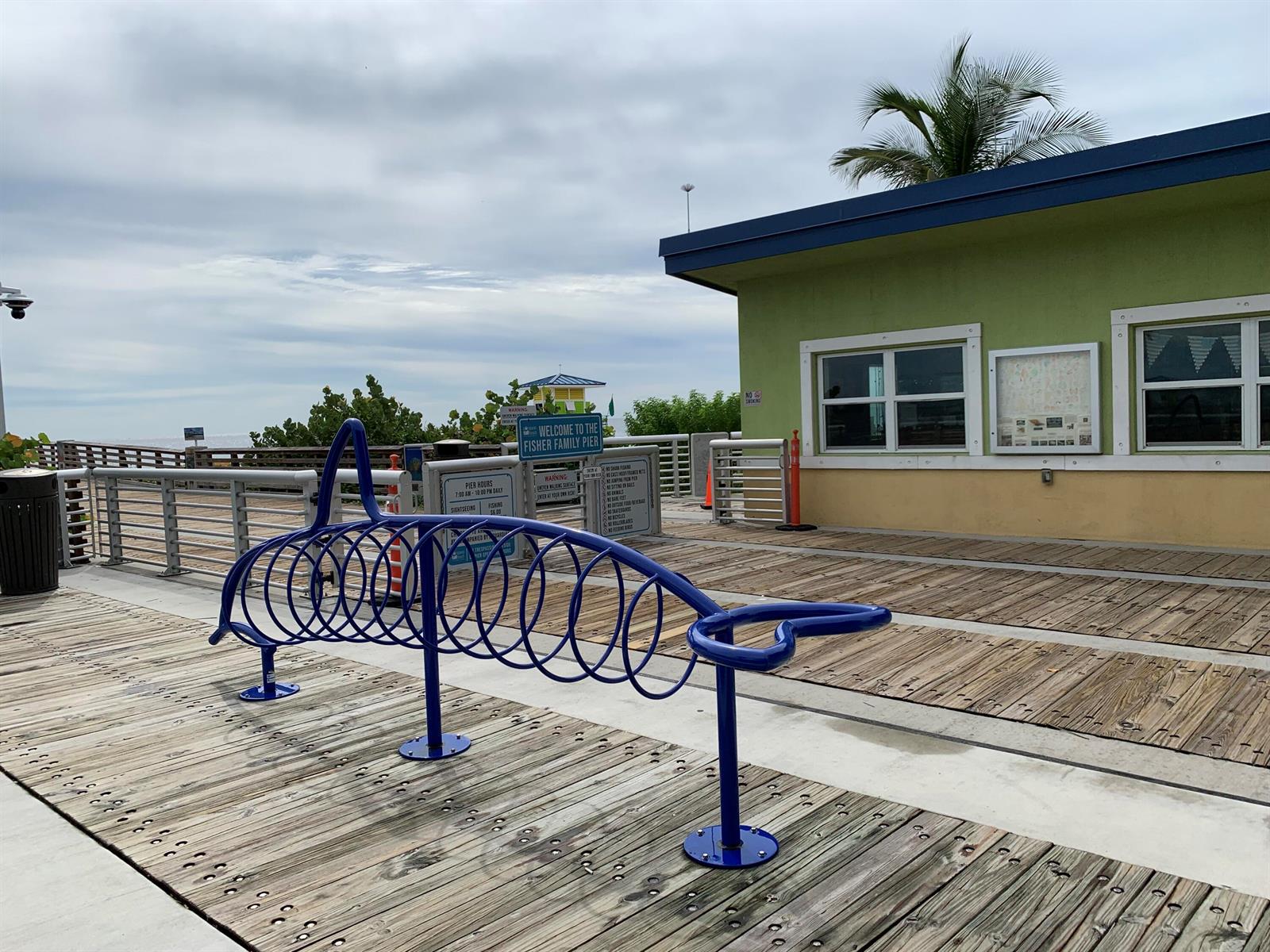 A paved path leads between two palm trees toward a sunny beach under a blue sky — 3208 SE 11th Street # 201, Pompano Beach FL 33062, POMPANO BEACH, FL