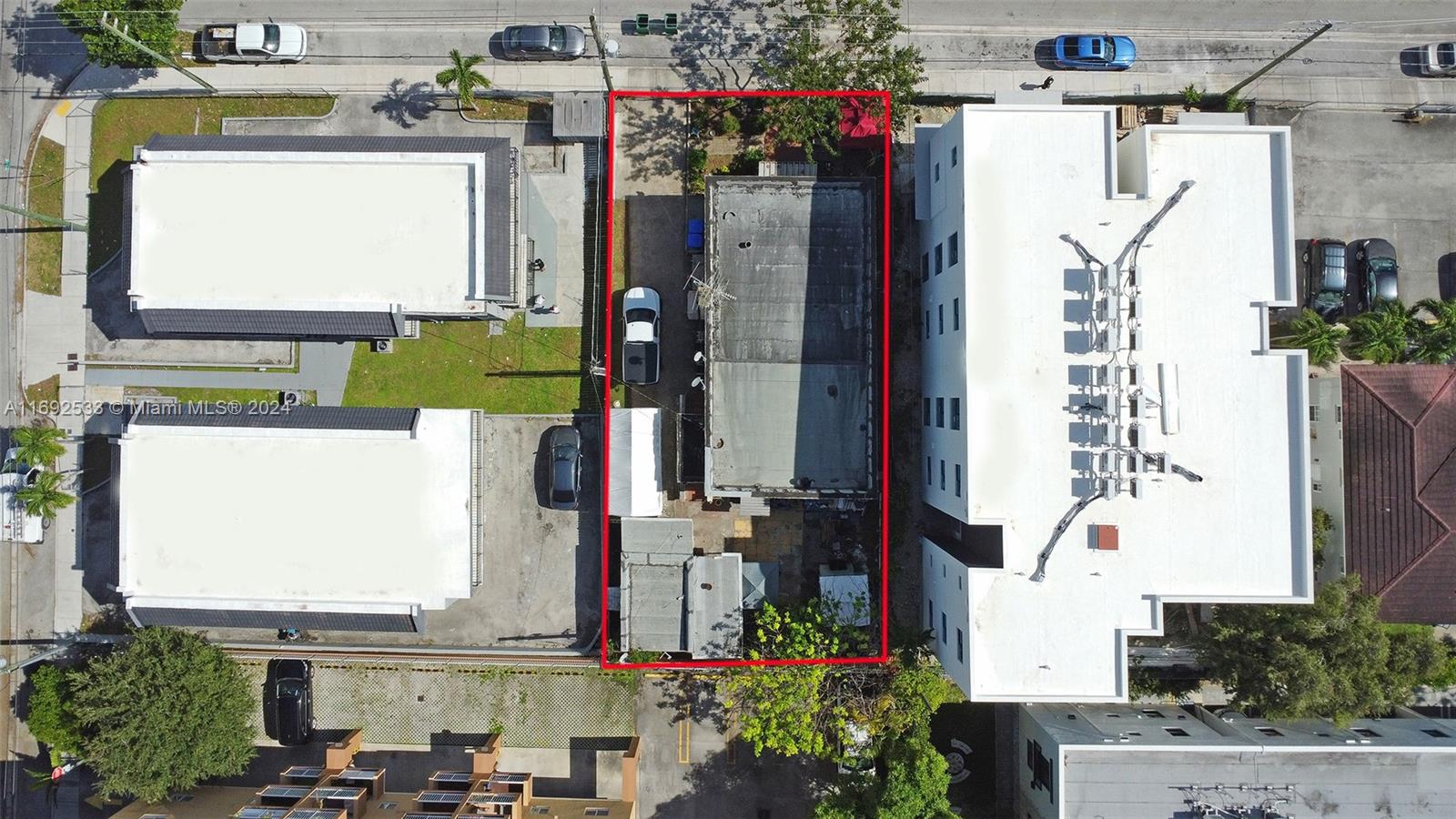 An aerial view shows a rectangular property lot outlined in red between two larger buildings — 520 SW 11th Ave, Miami FL 33130, MIAMI, FL
