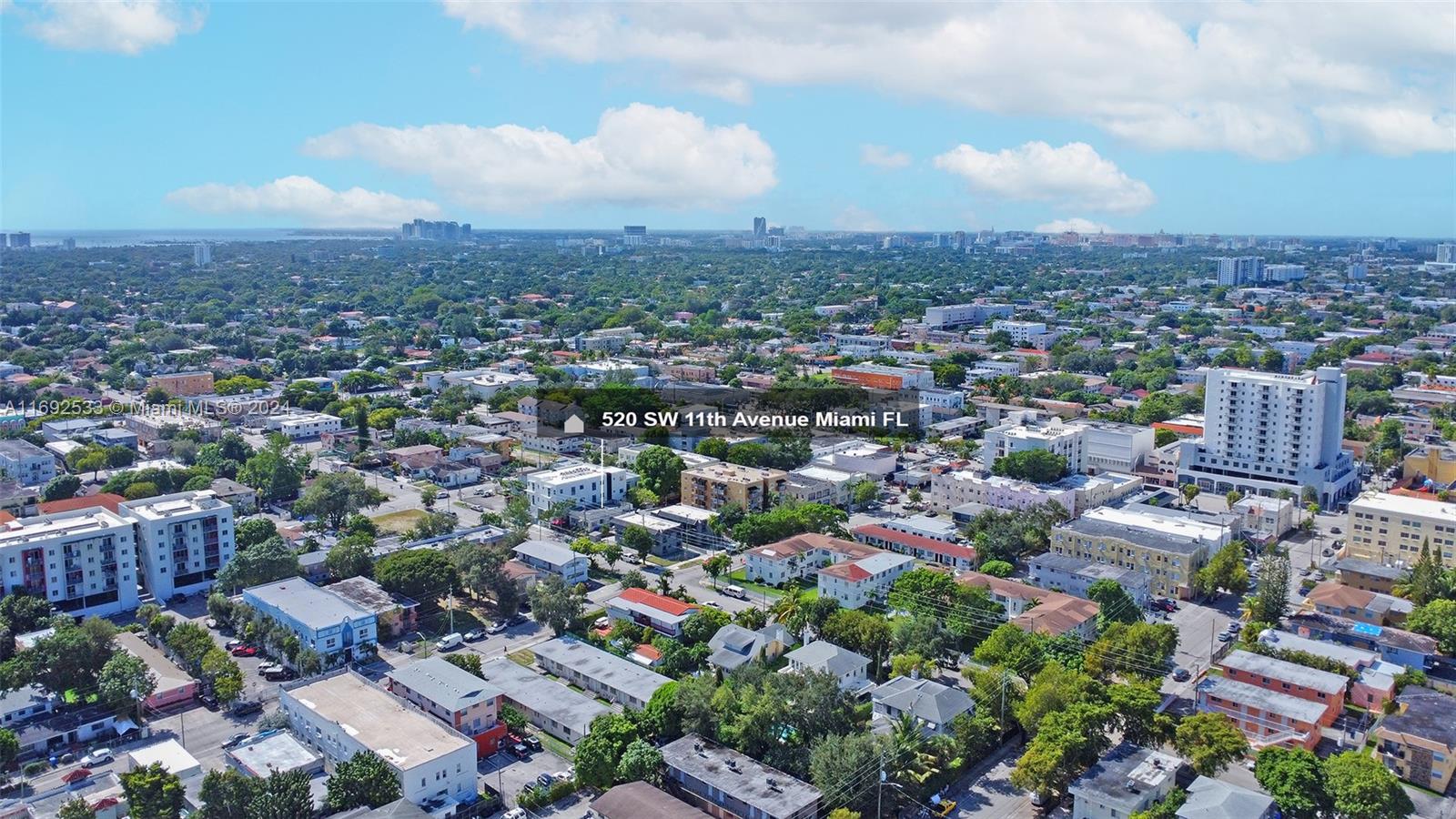 An aerial view shows a dense urban neighborhood with residential buildings and trees under a sky — 520 SW 11th Ave, Miami FL 33130, MIAMI, FL