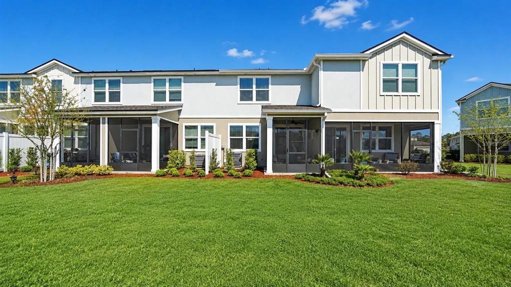 A kitchen featuring white cabinets, granite countertops, a stainless steel refrigerator, and a center island — 172 REDBUD ROAD, PALM COAST, FL