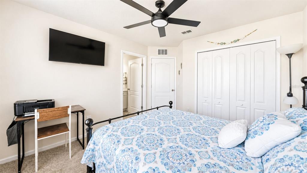 A kitchen features white cabinets, granite countertops, a center island, and stainless steel appliances — 172 REDBUD ROAD, PALM COAST, FL