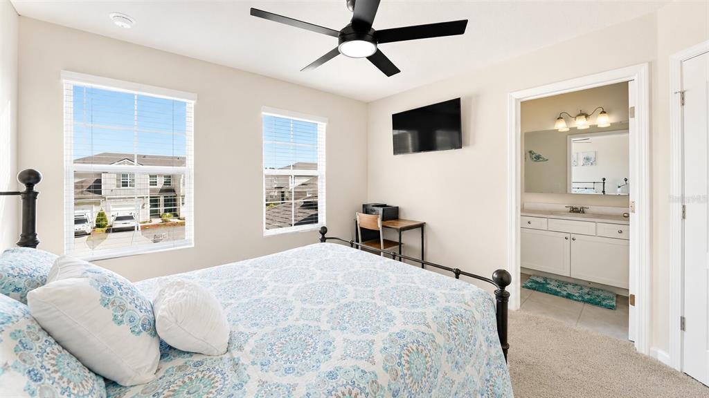 A kitchen island with a double sink overlooks an open living area with tile floors — 172 REDBUD ROAD, PALM COAST, FL