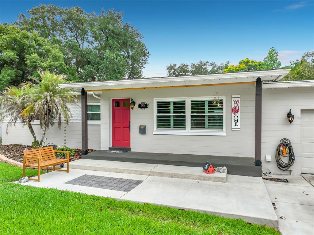 A single-story house exterior features a red front door, gray siding, and a concrete porch — 2806 VINE STREET, ORLANDO, FL
