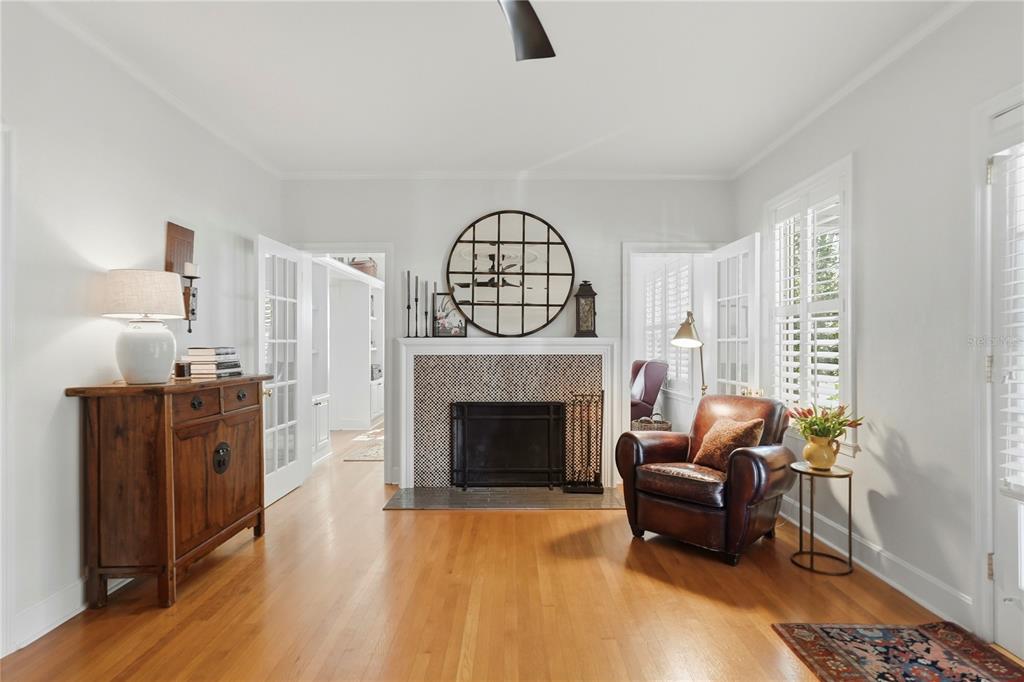 A living room features a fireplace with a tiled surround, a leather chair, and hardwood floors — 1325 24TH AVENUE N, ST PETERSBURG, FL