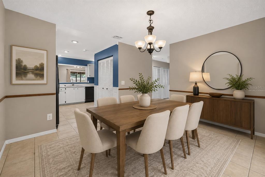 A dining room with a wooden table, six chairs, a chandelier, and a sideboard mirror — 512 DERBY DRIVE, ALTAMONTE SPRINGS, FL