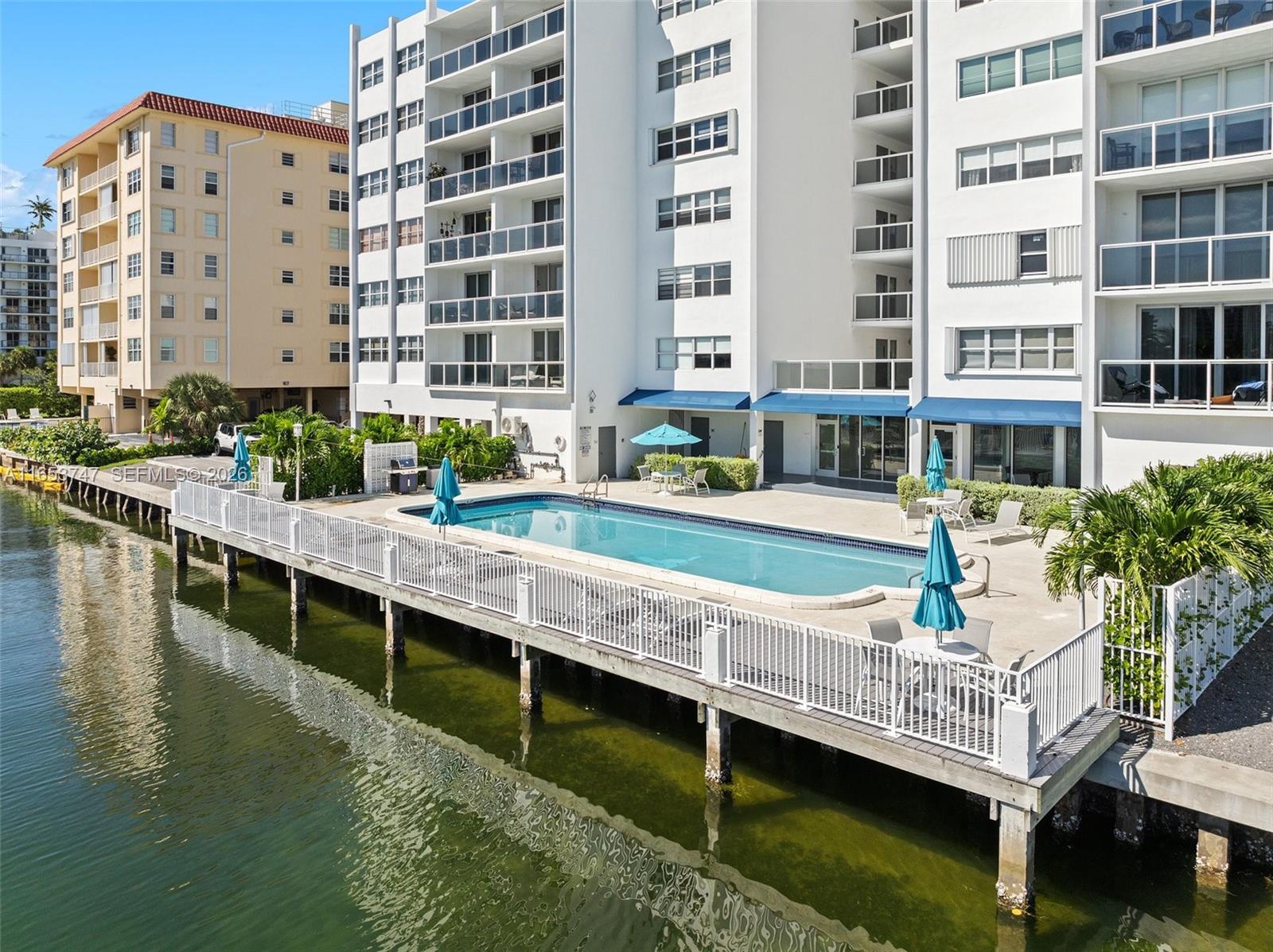 An elevated view of a swimming pool on a deck overlooking a canal — 9381 E Bay Harbor Dr # 603S, Bay Harbor Islands FL 33154, BAY HARBOR ISLANDS, FL