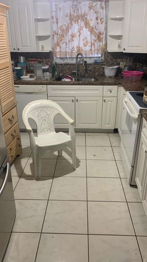 A kitchen with white cabinets, granite countertops, tile flooring, and a white plastic chair — 2070 NE 2nd Avenue, Pompano Beach FL 33060, POMPANO BEACH, FL