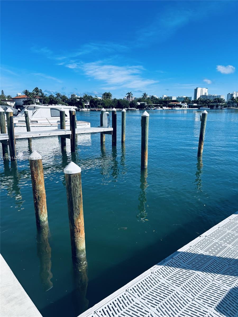 A view of a wooden boat dock and pilings extending into a calm bay — 4701 N Meridian, Miami Beach FL 33140, MIAMI BEACH, FL