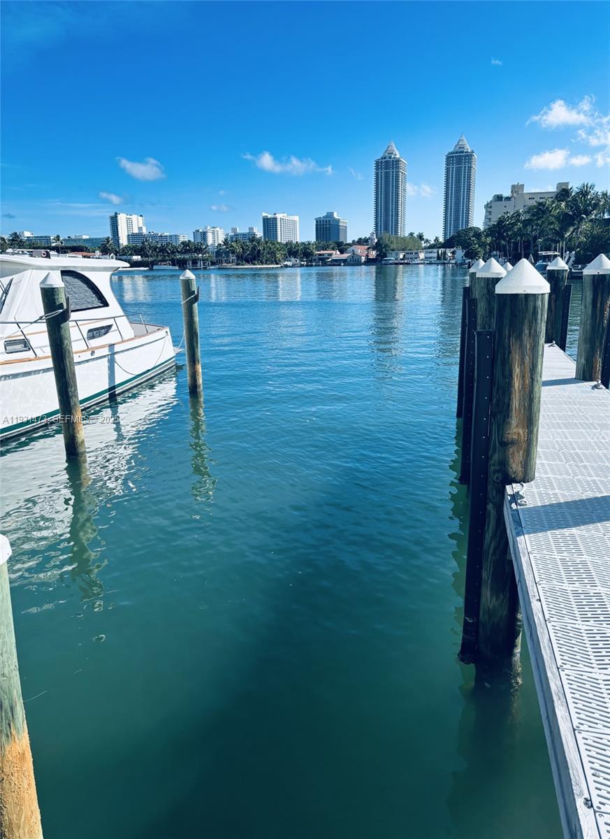 A view of a calm waterway with a docked boat and city skyline in background — 4701 N Meridian, Miami Beach FL 33140, MIAMI BEACH, FL