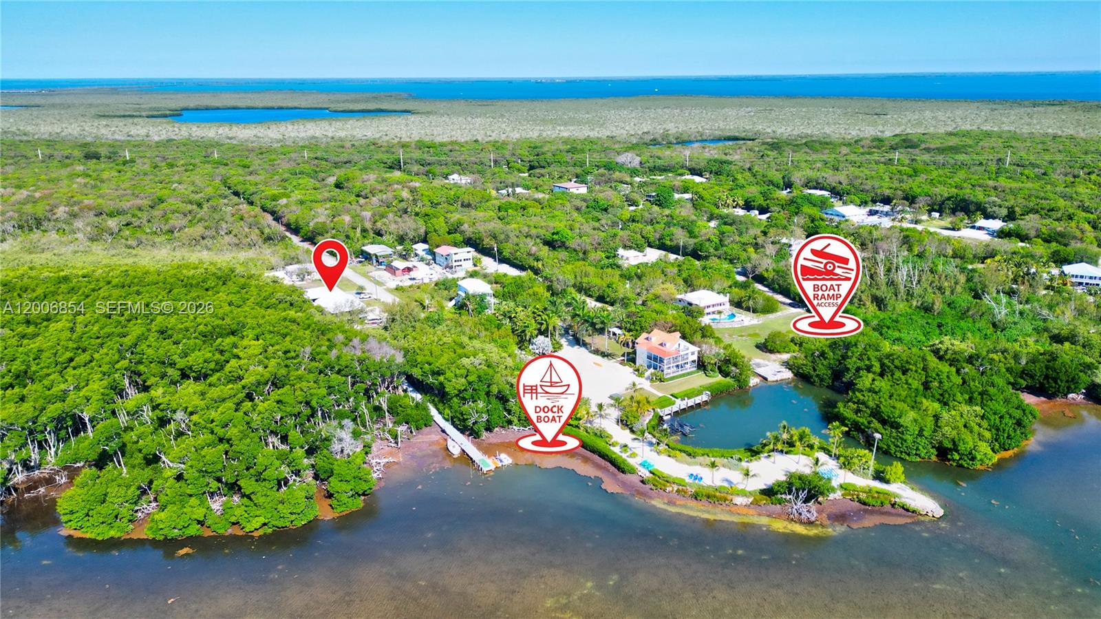 This aerial view shows a coastal property with a boat dock and ramp access — 34 Atlantic Drive, Marathon FL 33037, MARATHON, FL