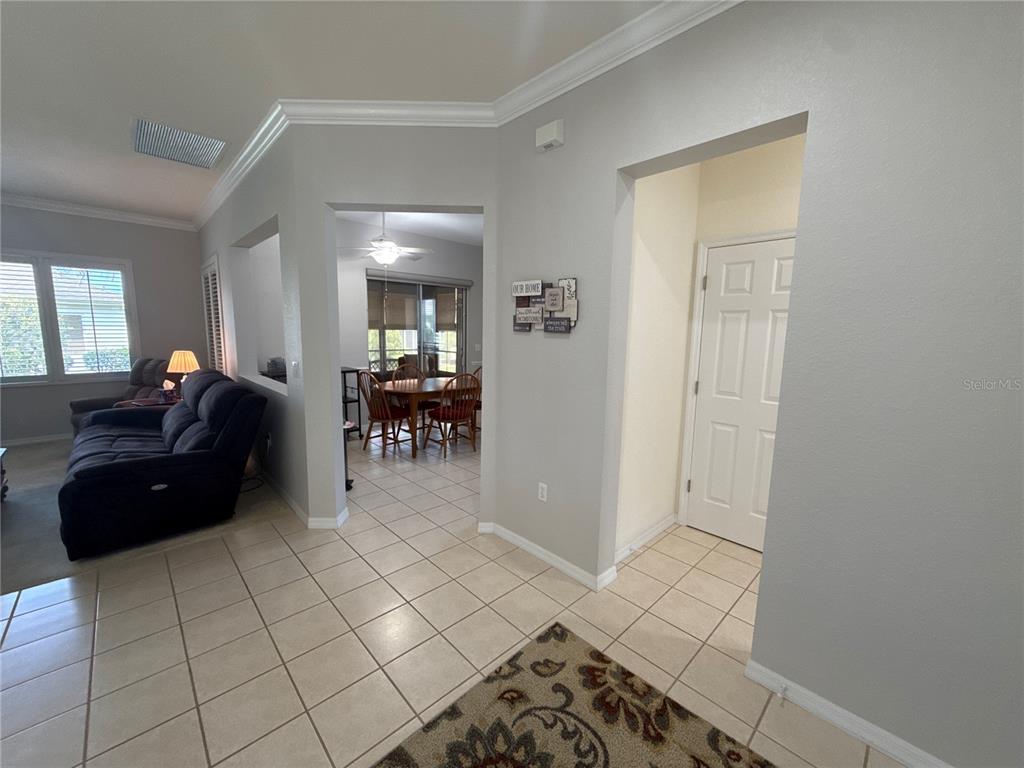 A tiled entryway leads to a living room and a dining area with a ceiling fan — 9484 SE 124TH LOOP, SUMMERFIELD, FL