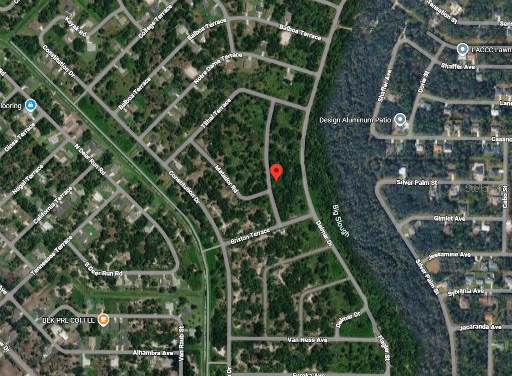 This is a satellite map view of a residential neighborhood with a red location pin — Lot 13 BANGAR LANE, NORTH PORT, FL