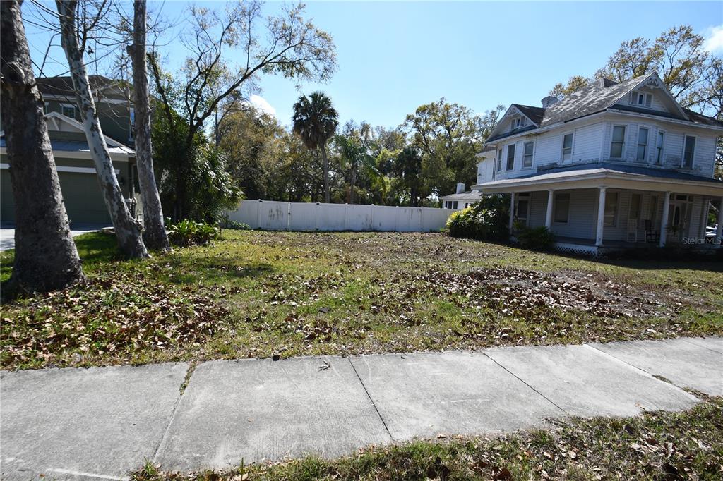 A vacant grassy lot sits between a modern house and a historic two-story home — 8020 INTERBAY BOULEVARD, TAMPA, FL