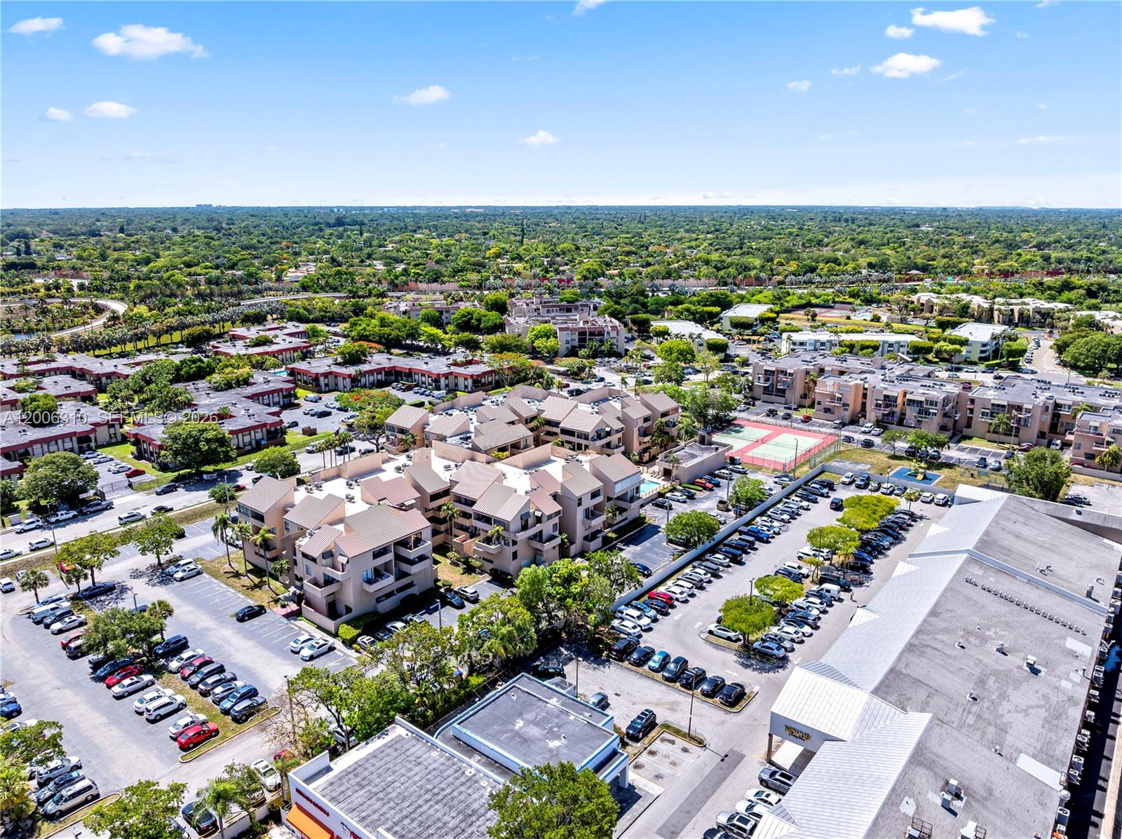 An aerial view shows multi-story apartment buildings, parking lots, and a tennis court — 10500 SW 108th Ave # B211, Miami FL 33176, MIAMI, FL