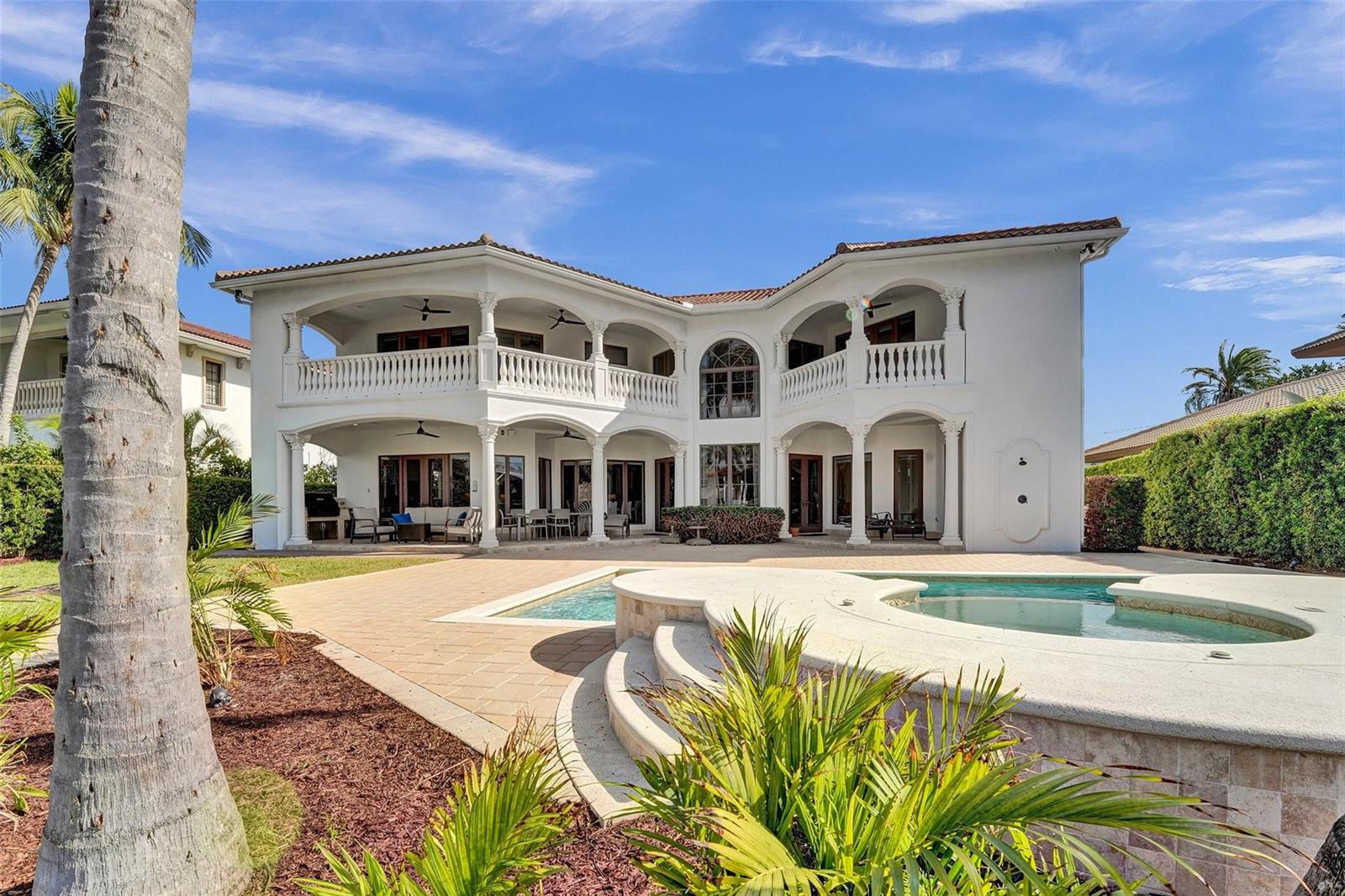 A two-story white Mediterranean-style house features a pool, spa, and covered balconies — 642 Palm Drive, Hallandale Beach FL 33009, HALLANDALE BEACH, FL