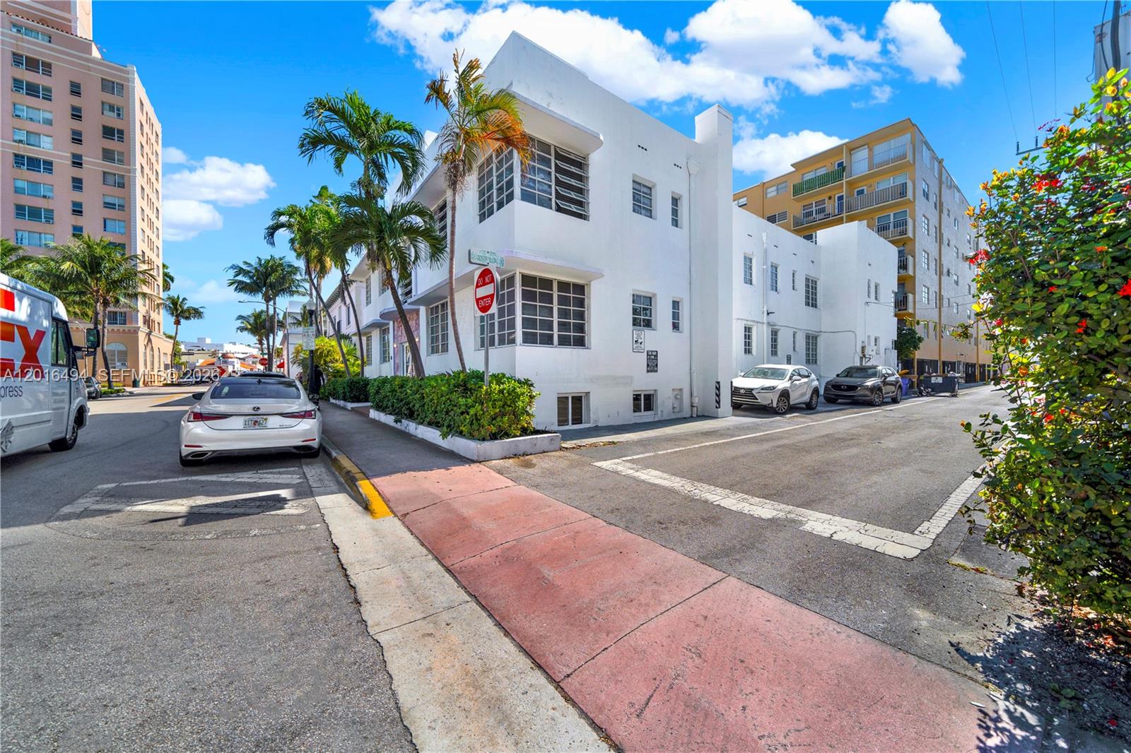 A white multi-story building with palm trees stands at a street corner under a sky — 610 8th St # 102, Miami Beach FL 33139, MIAMI BEACH, FL
