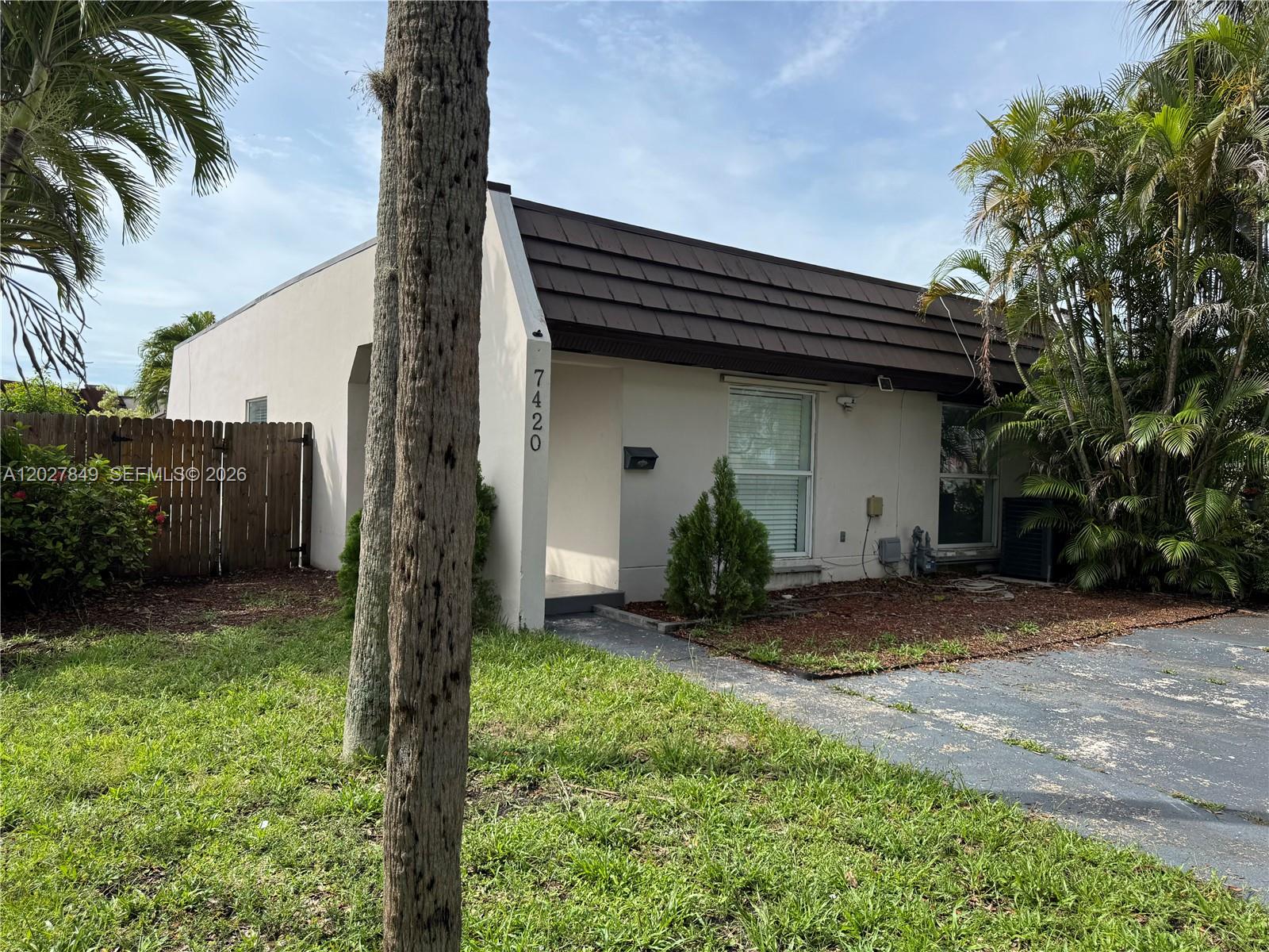 A single-story house with a brown mansard roof and a small front yard — 7420 Big Cypress Dr, Miami Lakes FL 33014, MIAMI LAKES, FL