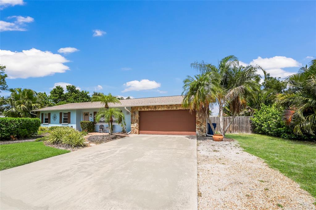 An aerial view shows a house with a shingled roof, a pool, and a driveway — 1004 68TH STREET NW, BRADENTON, FL