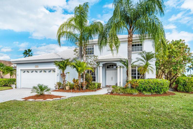 A two-story house with a white exterior, a tiled roof, and palm trees in front — 21958 Palm Grass Drive, Boca Raton FL 33428, BOCA RATON, FL