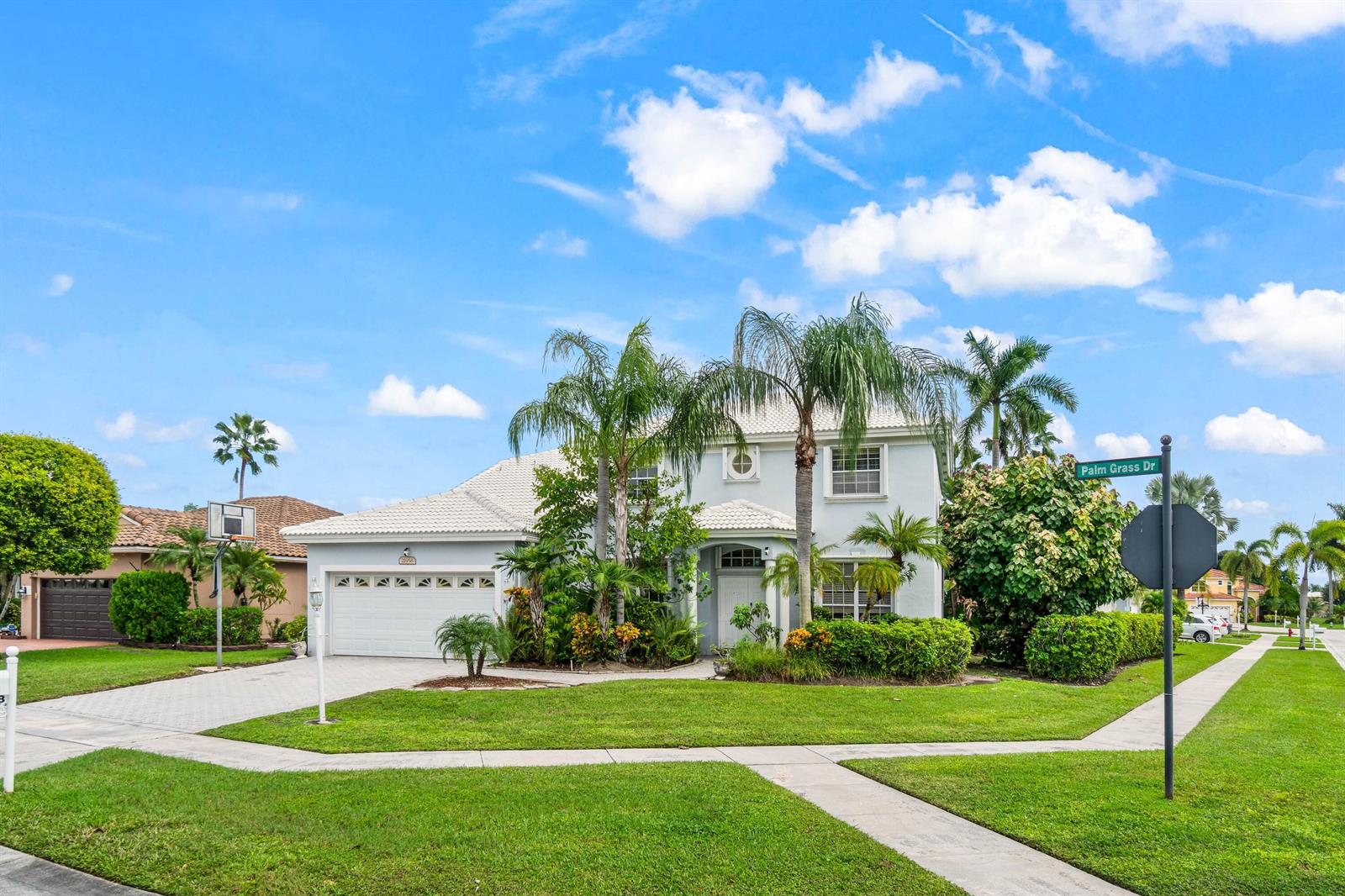 A two-story light blue house with a white tile roof and palm trees in front — 21958 Palm Grass Drive, Boca Raton FL 33428, BOCA RATON, FL