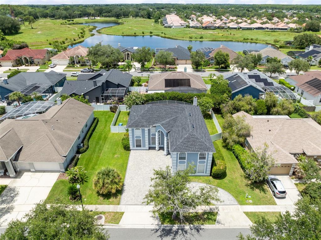 An aerial view shows a suburban house with a paved driveway and a backyard pool — 224 HAMMOCK DUNES PLACE, ORLANDO, FL