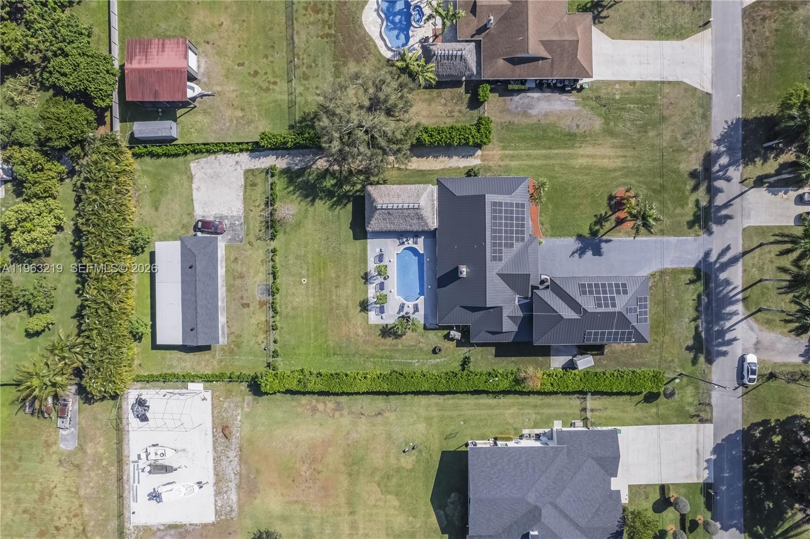 An aerial view shows a house with a pool, solar panels, and a detached garage — 14651 SW 16th St, Davie FL 33325, DAVIE, FL