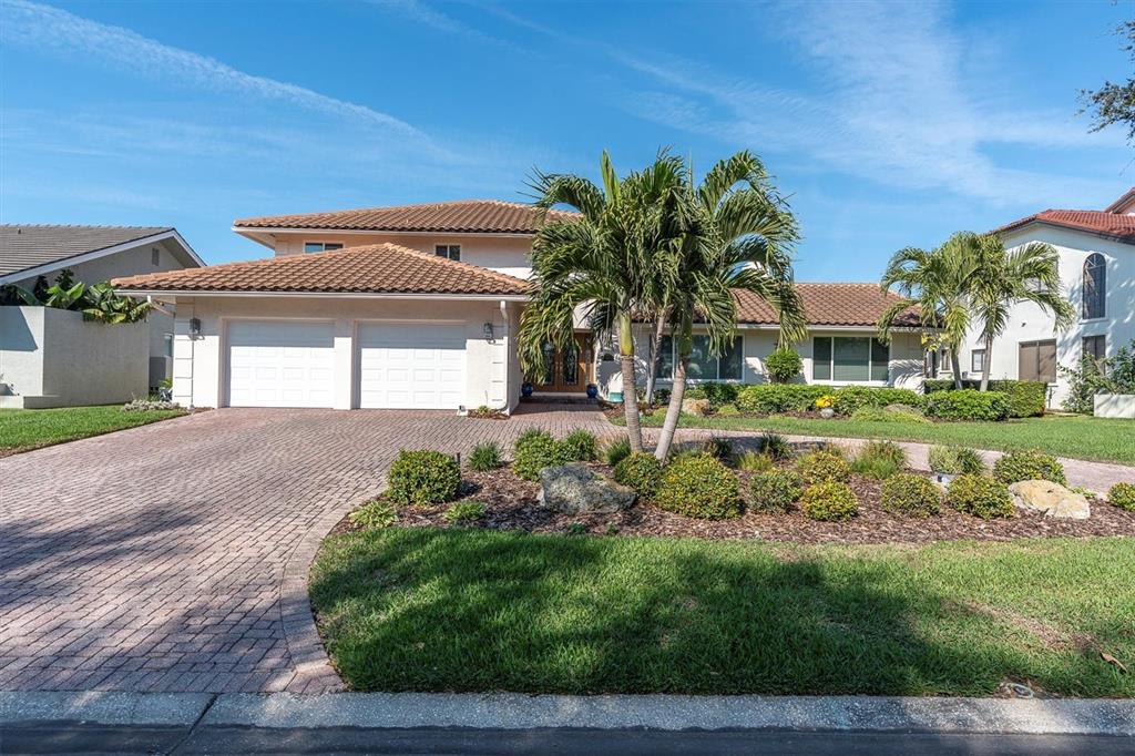 A two-story house with a tile roof, two-car garage, and a landscaped front yard — 4961 61ST AVENUE S, ST PETERSBURG, FL
