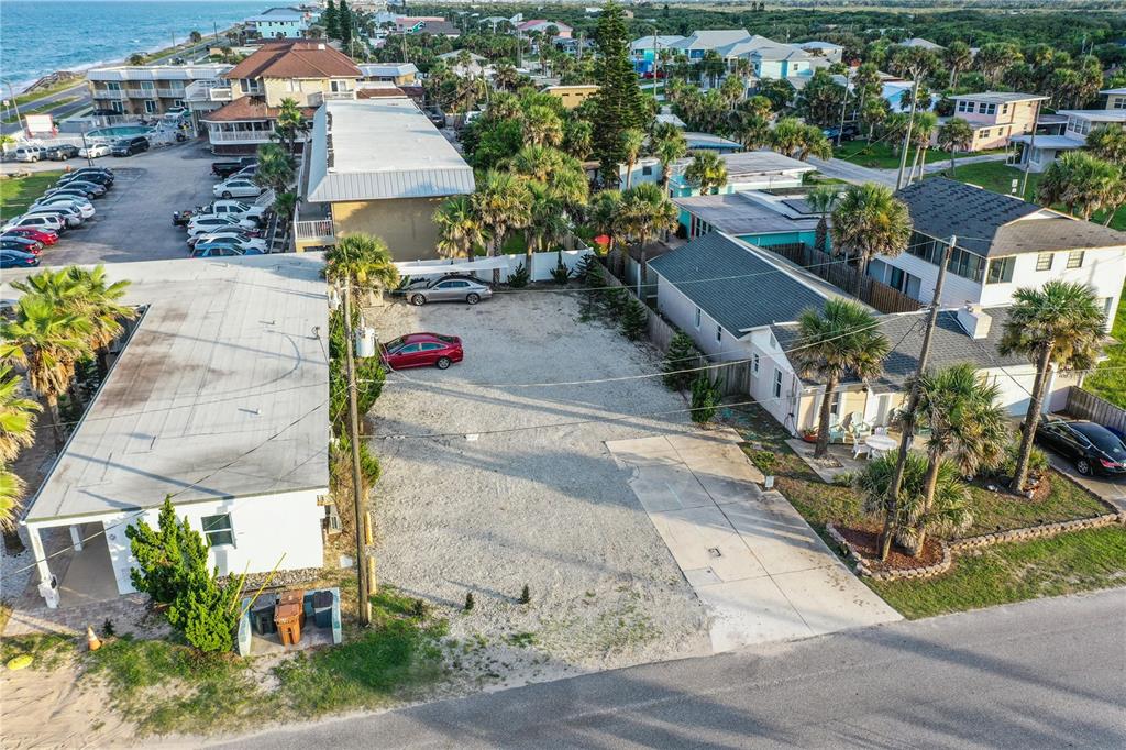 An aerial view shows a gravel parking lot situated between two residential buildings — 111 S 12TH STREET, FLAGLER BEACH, FL