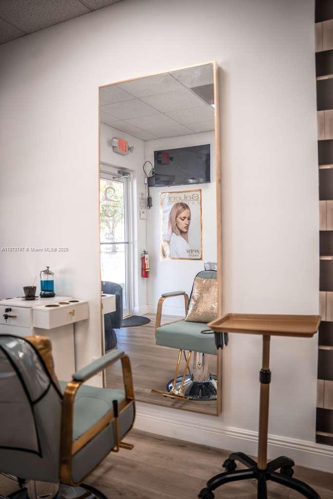 A hair salon station features a large wall mirror, a styling chair, and a rolling tray — 825 E COWBOY WAY, La Belle FL 33935, LA BELLE, FL