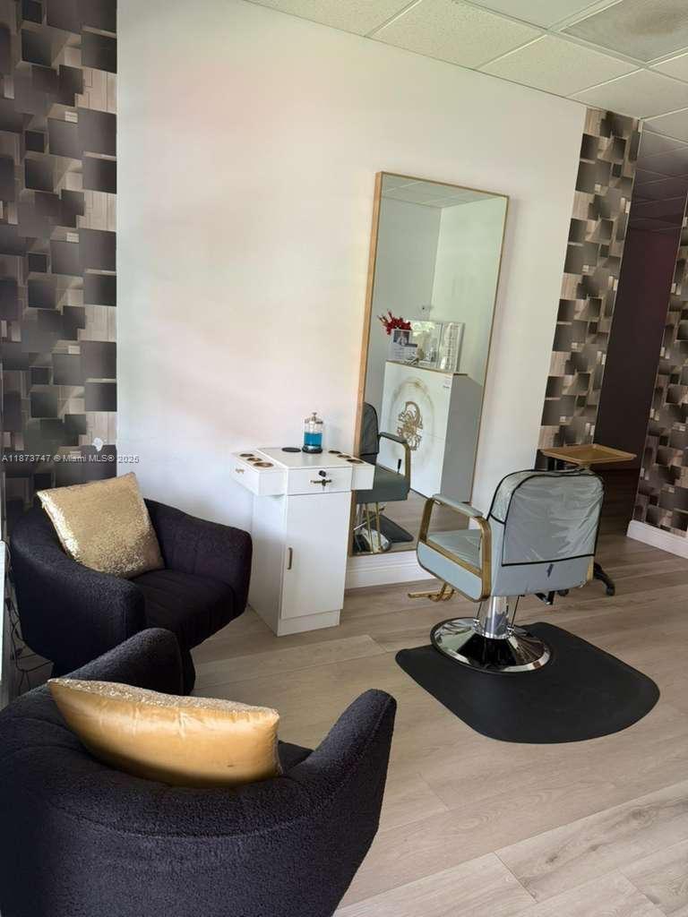 A salon station features a styling chair, a mirror, and two dark armchairs — 825 E COWBOY WAY, La Belle FL 33935, LA BELLE, FL