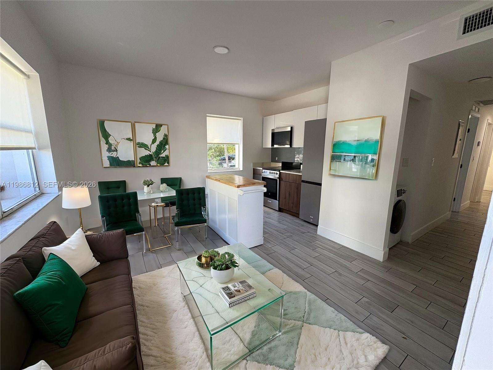 An aerial view of a two-story white apartment building with orange accents and parked cars — 1000 7th St # 10, Miami Beach FL 33139, MIAMI BEACH, FL