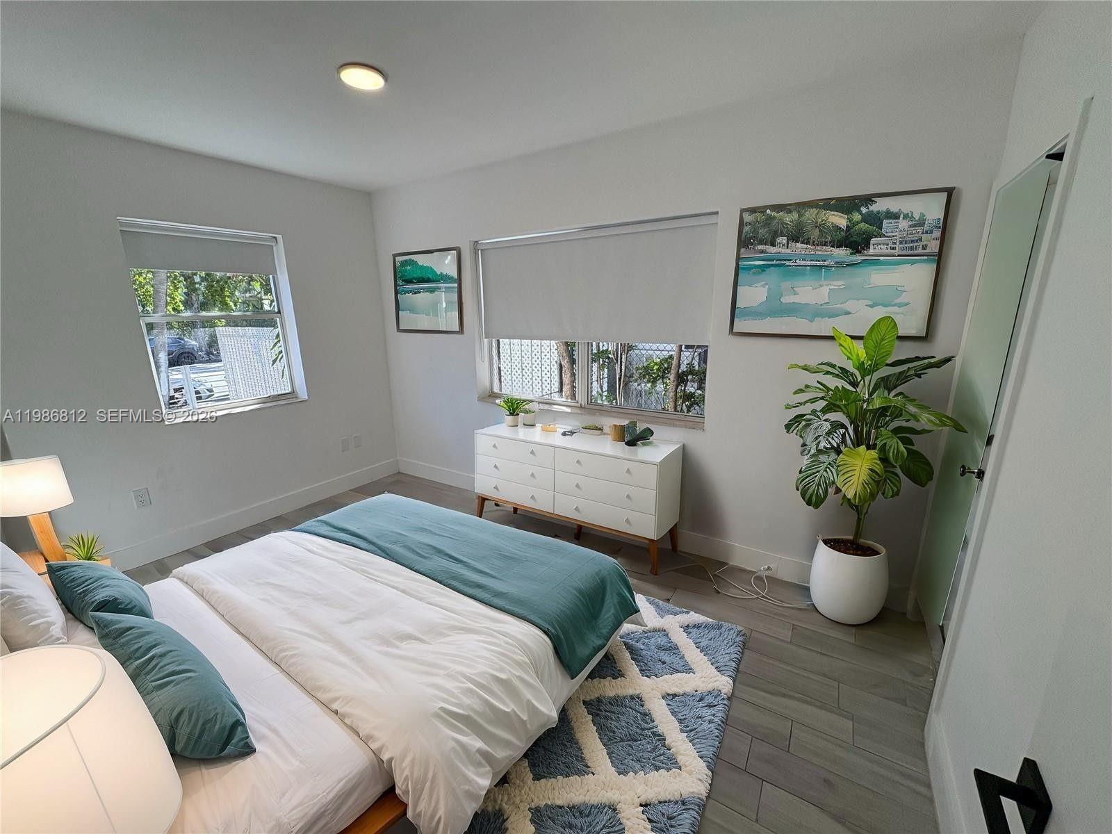 A living room and kitchen area with a brown sofa, glass coffee table, and dining set — 1000 7th St # 10, Miami Beach FL 33139, MIAMI BEACH, FL