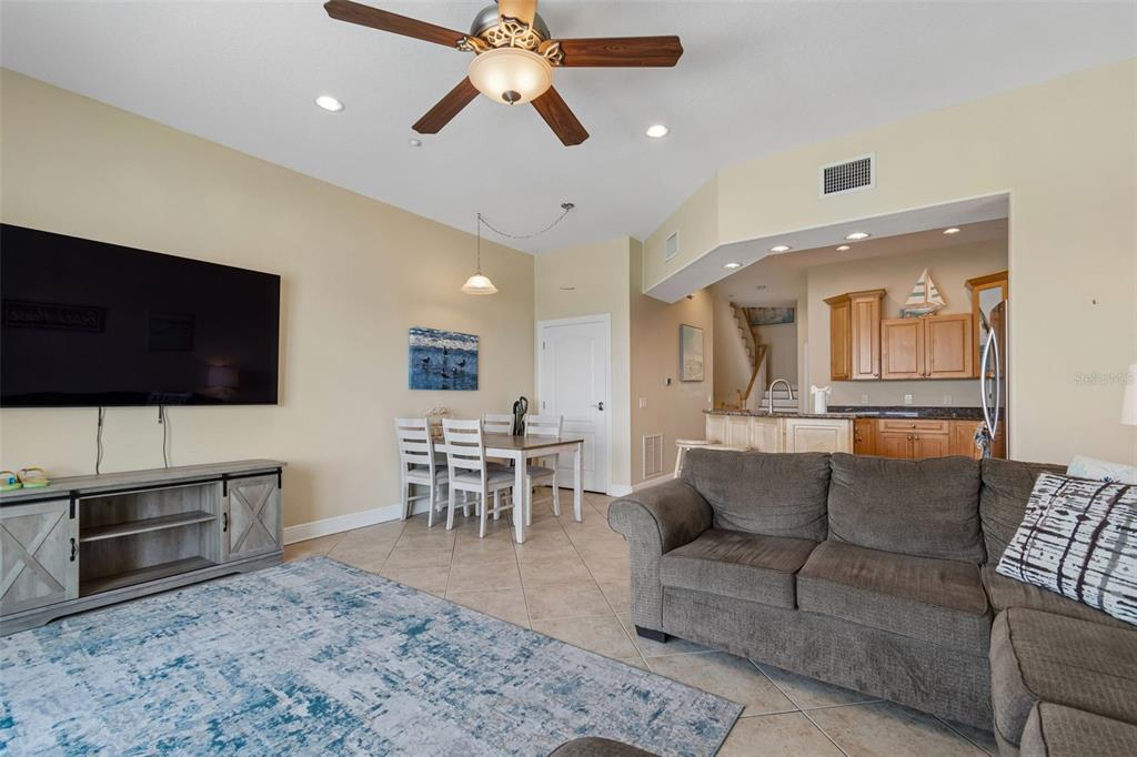 A kitchen with light wood cabinets, granite countertops, a center island, and a water view — 620 BAYWAY BOULEVARD UNIT 5, CLEARWATER BEACH, FL