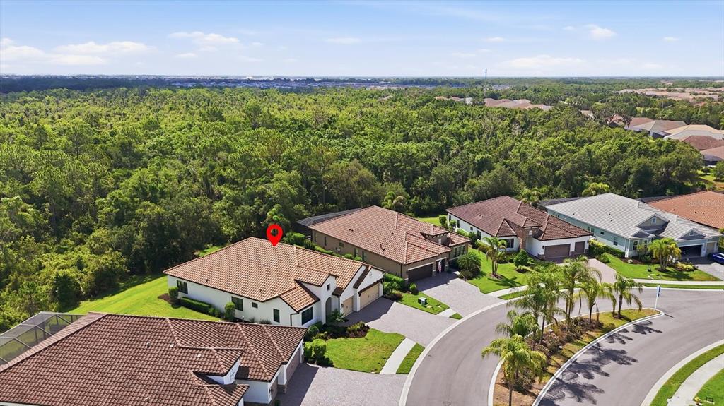 A covered patio features a textured wall with electrical outlets and plumbing hookups — 13231 INDIGO WAY, BRADENTON, FL