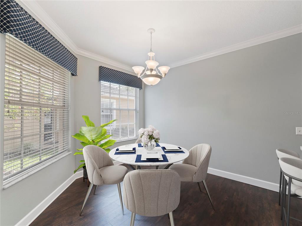 A kitchen features white cabinets, stainless steel appliances, a center island, and quartz countertops — 19111 LAKE AUDUBON DRIVE, TAMPA, FL