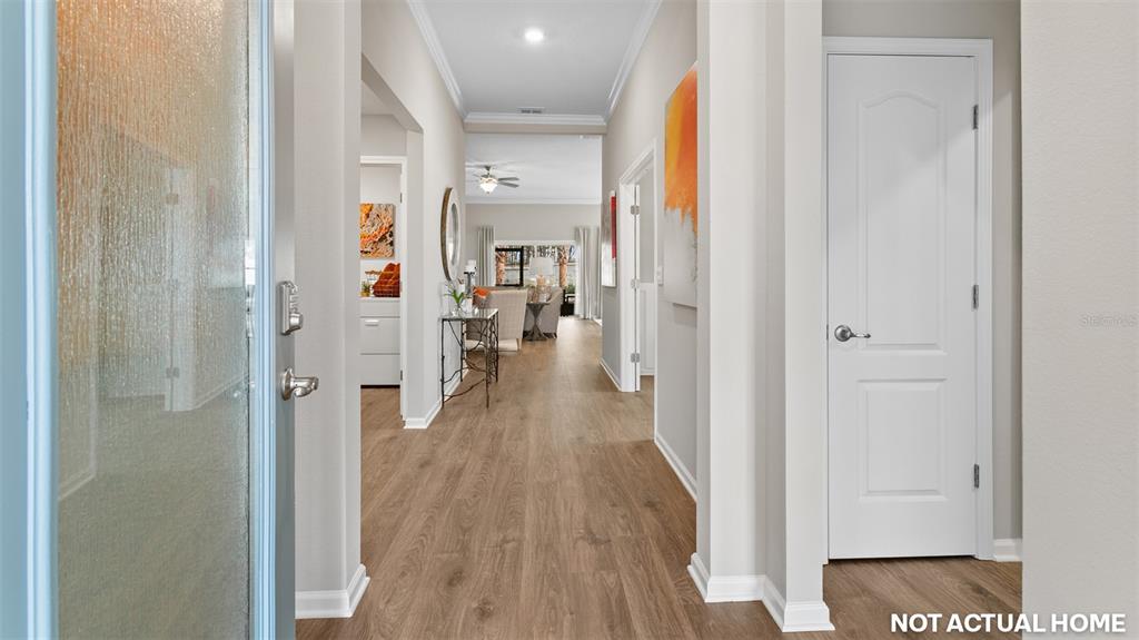 This is a rendering of a home interior featuring a hallway with wood-look flooring — 52 HARDWOOD TRAIL, PALM COAST, FL