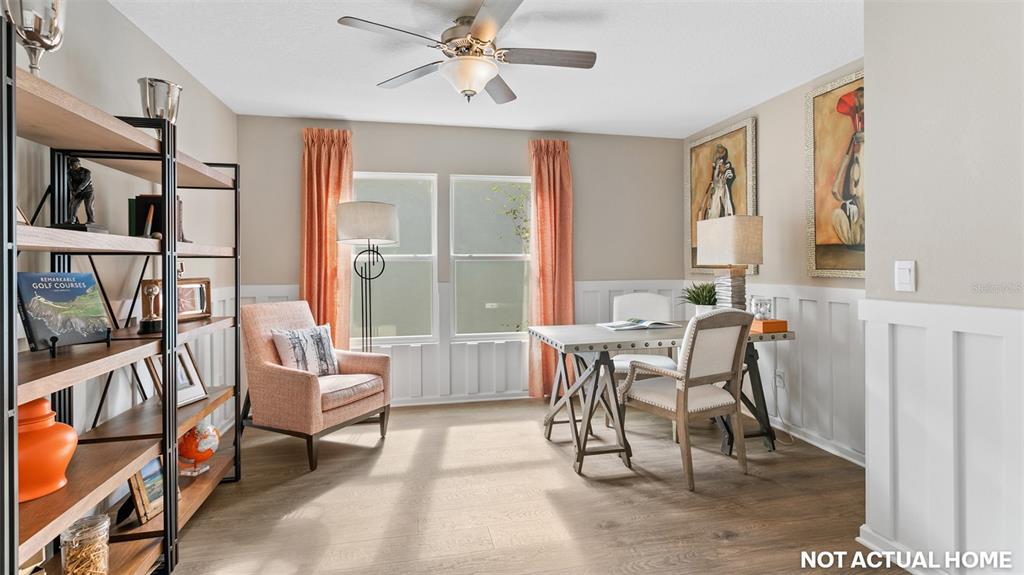 This is a rendering of a home office featuring wood floors, wainscoting, and a desk — 52 HARDWOOD TRAIL, PALM COAST, FL