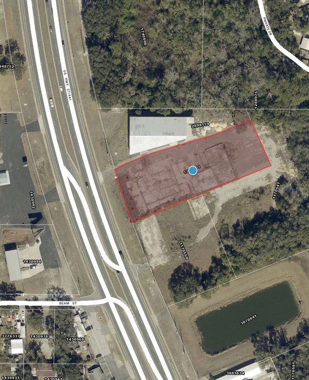 This is an aerial map view showing a rectangular parcel of land highlighted in red — 3131 US HIGHWAY 441 / 27, FRUITLAND PARK, FL